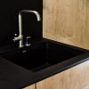 Kitchen with KOHLER Purist faucet, Bento Build Lattice kitchen cabinet system, countertop made of Richlite. Richlite is made from recycled and FSC paper. It's color goes all the way through and therefore can be sanded.